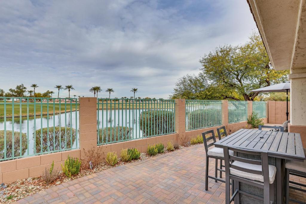 a patio with a table and chairs and a fence at Goodyear Home with Private Patio and Golf Course View in Goodyear