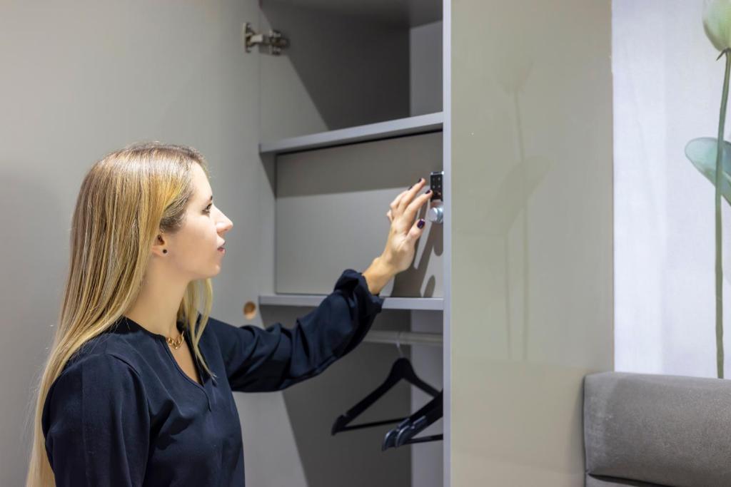 a woman taking a picture of a door at Dem Premium Hotel - Round Trip Airport Service - Istanbul International Airport in Arnavutköy