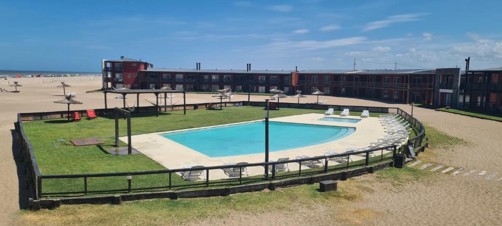 an overhead view of a swimming pool in front of a building at Chacras del Mar - Acceso exclusivo vehiculo 4 x 4 in Mar Azul