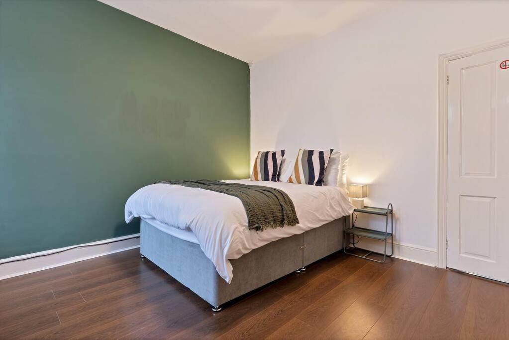 - une chambre dotée d'un lit avec un mur bleu dans l'établissement Becky's House: Near Motor Point Arena with Free Parking, à Nottingham
