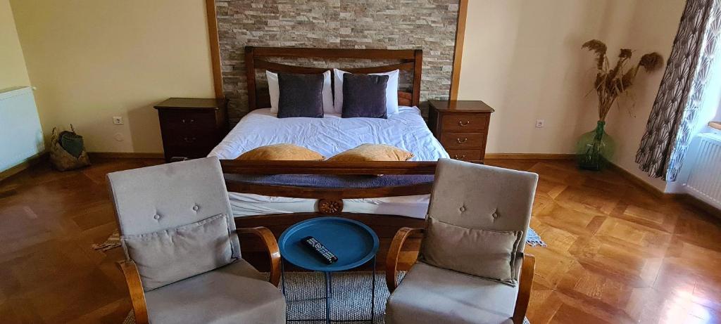 - une chambre avec un lit et 2 chaises dans l'établissement Schei apartments, à Braşov
