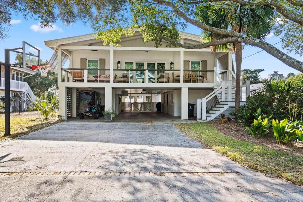 a large white house with a porch at It is a Happy Day at the Beach in Pawleys Island