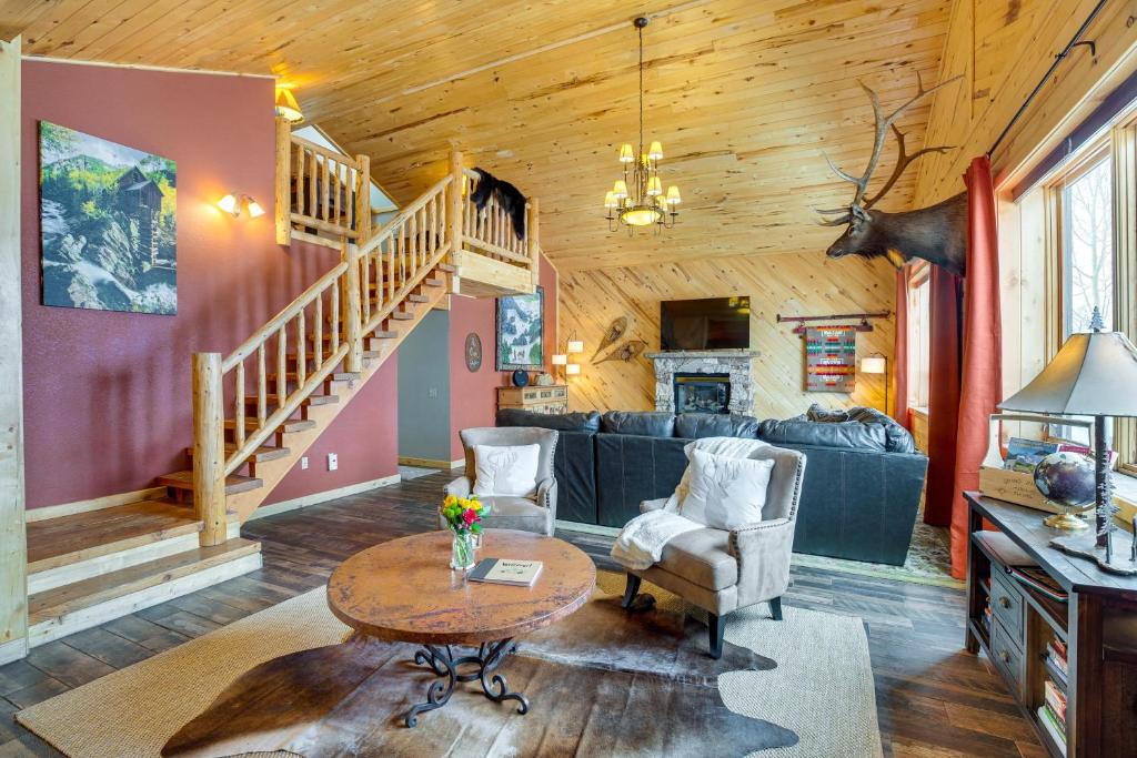a living room with a spiral staircase in a cabin at Spacious Gunnison Home Ski, Hike, Bike and Fish! in Gunnison