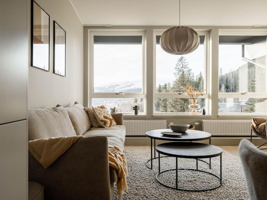 a living room with a couch and a table at Chic Are Apt for 6 Ski-in-Ski-out with Sauna in Åre