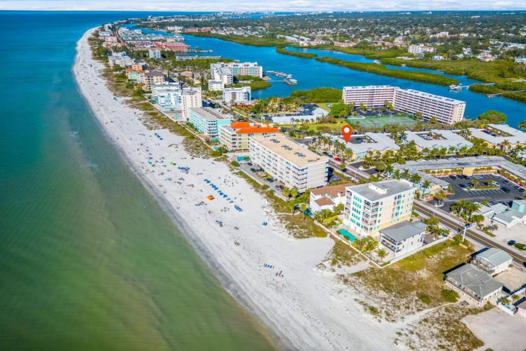 an aerial view of the beach and buildings at Beach Condo with Game Room Steps To Beach in Clearwater Beach