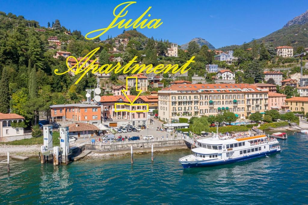 a view of a town with a boat in the water at Apartment Julia - Menaggio in Menaggio