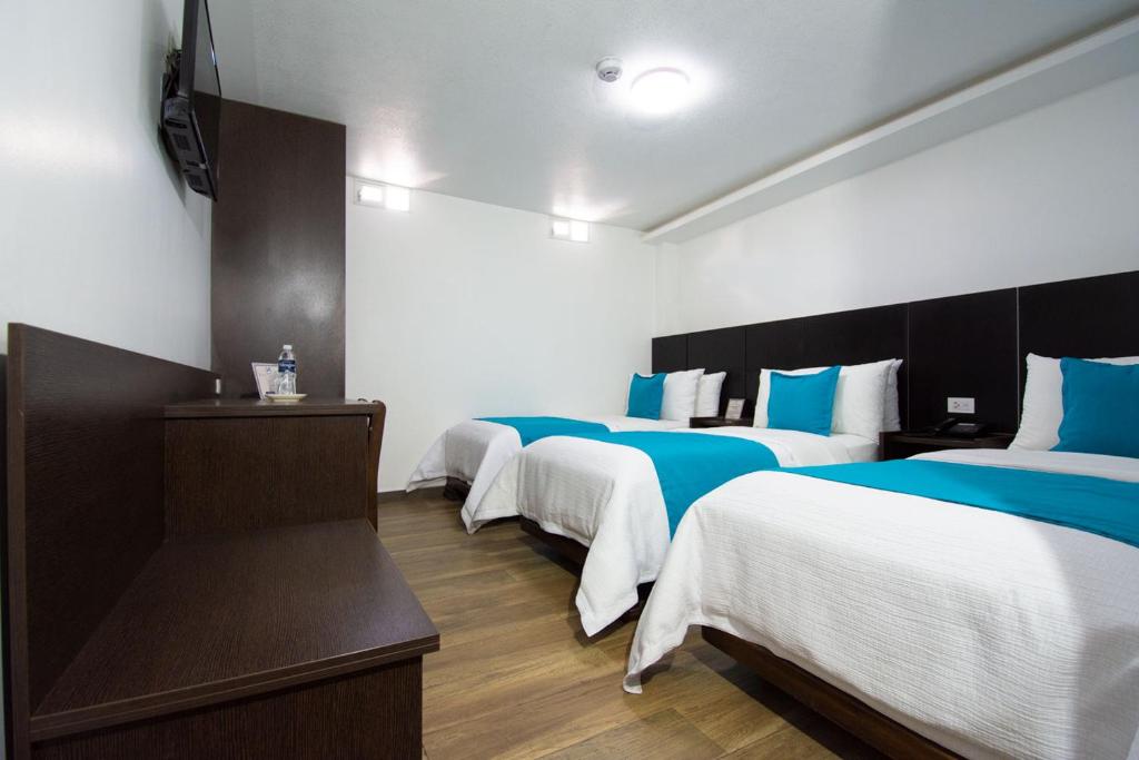 Postel nebo postele na pokoji v ubytování Hotel Plaza Victoria