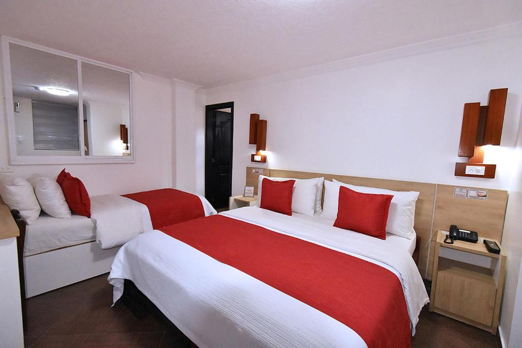 Postel nebo postele na pokoji v ubytování Hotel Plaza Victoria
