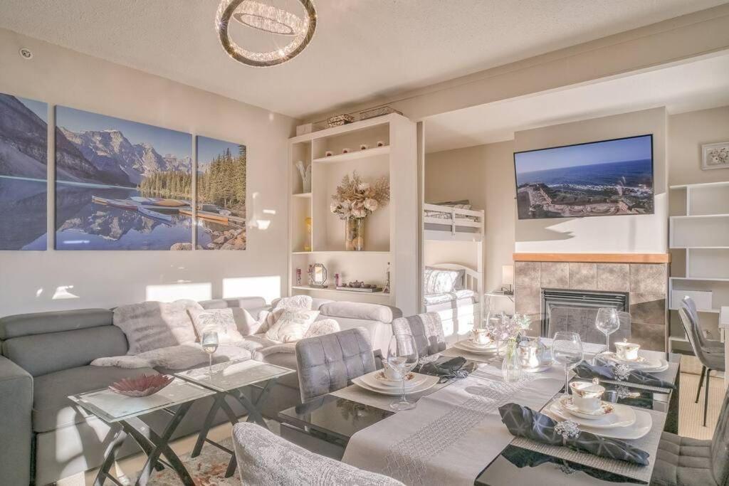 a living room with a couch and a table at Mountain Escape sleeps 10 Guests in this 3BD 2BT Top Floor Condo with Mountain View in Canmore