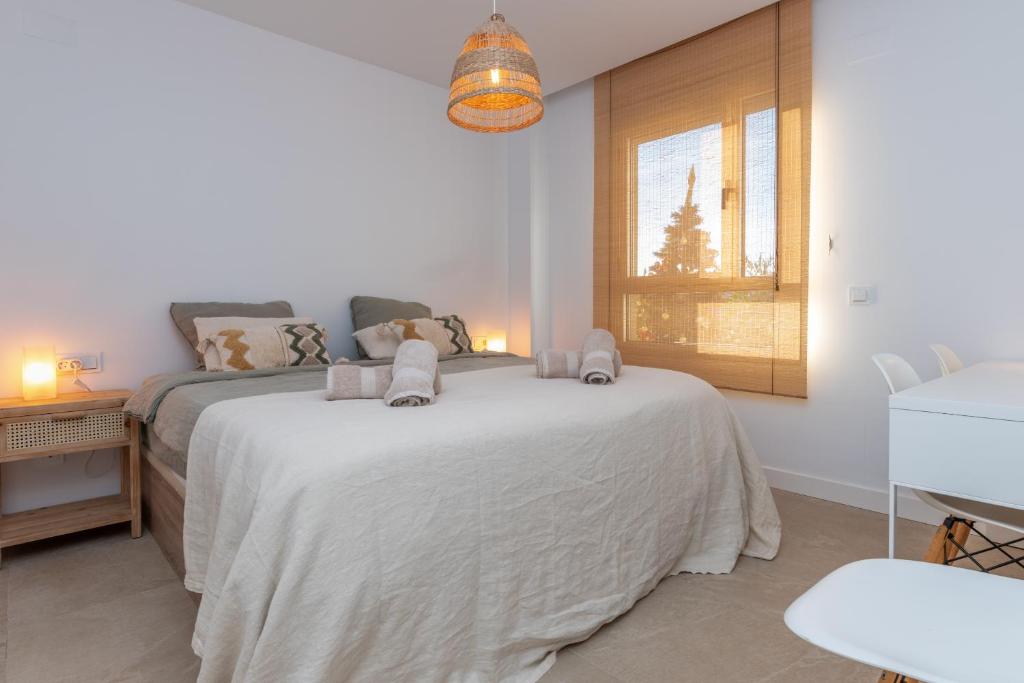 A bed or beds in a room at Chic 3BR Haven - Luxury Ground Floor - La Cala Golf