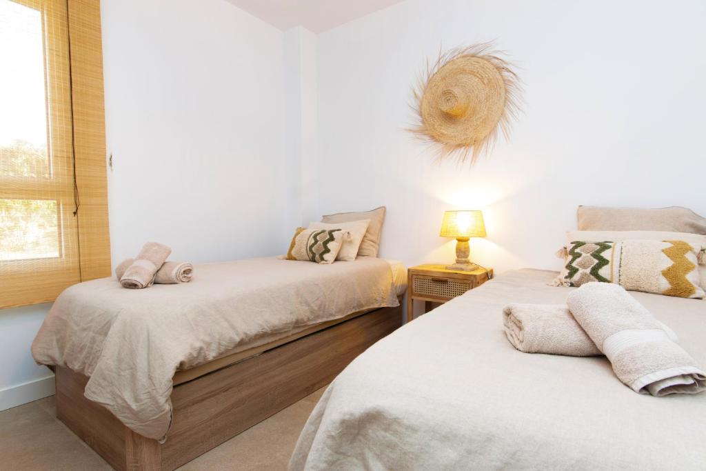 A bed or beds in a room at Chic 3BR Haven - Luxury Ground Floor - La Cala Golf