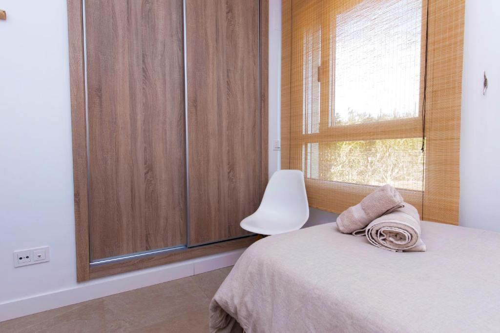 A bed or beds in a room at Chic 3BR Haven - Luxury Ground Floor - La Cala Golf
