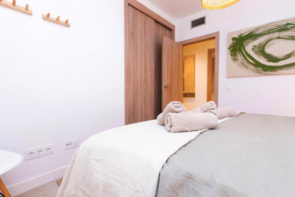 A bed or beds in a room at Chic 3BR Haven - Luxury Ground Floor - La Cala Golf