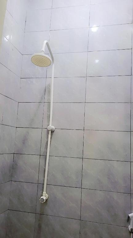 a shower head on the wall of a bathroom at F&D villas in Dar es Salaam