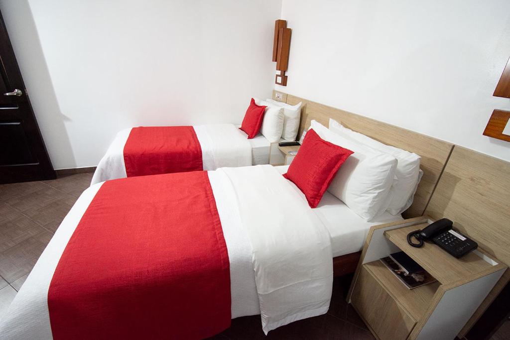 Postel nebo postele na pokoji v ubytování Hotel Plaza Victoria