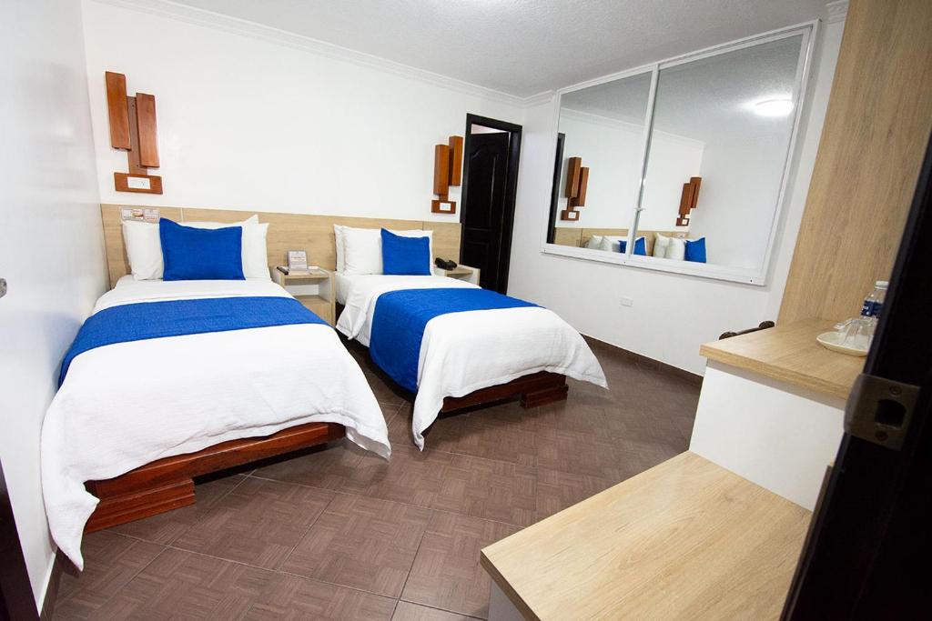 Postel nebo postele na pokoji v ubytování Hotel Plaza Victoria
