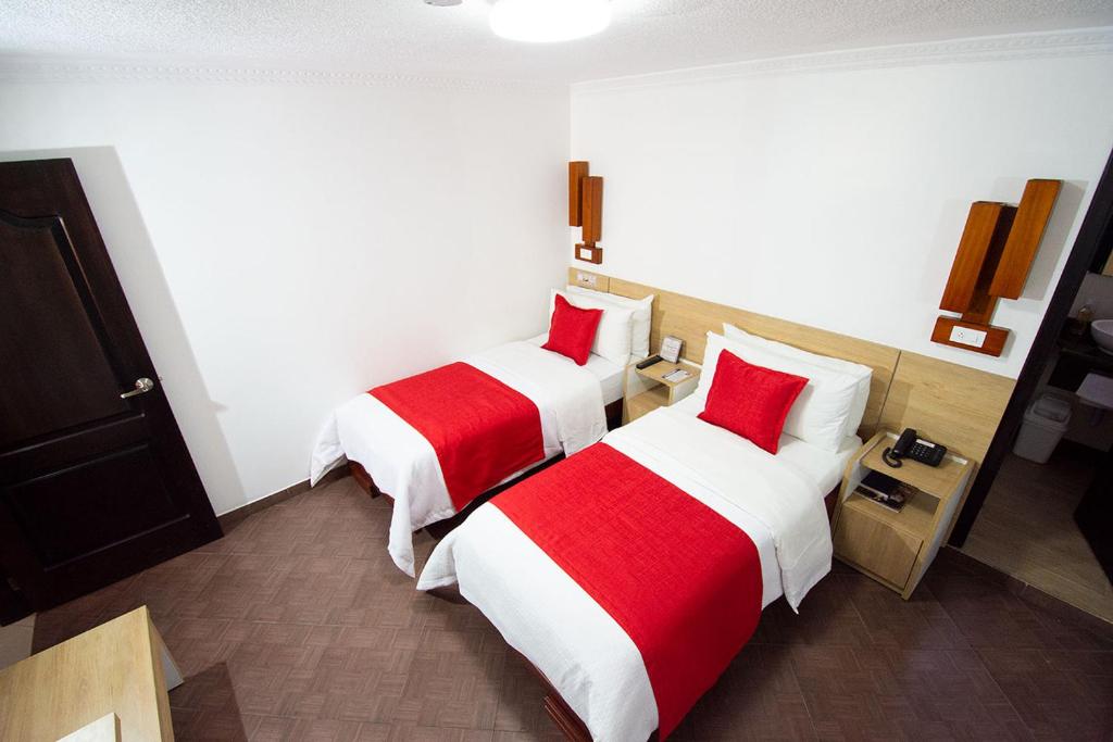 Postel nebo postele na pokoji v ubytování Hotel Plaza Victoria
