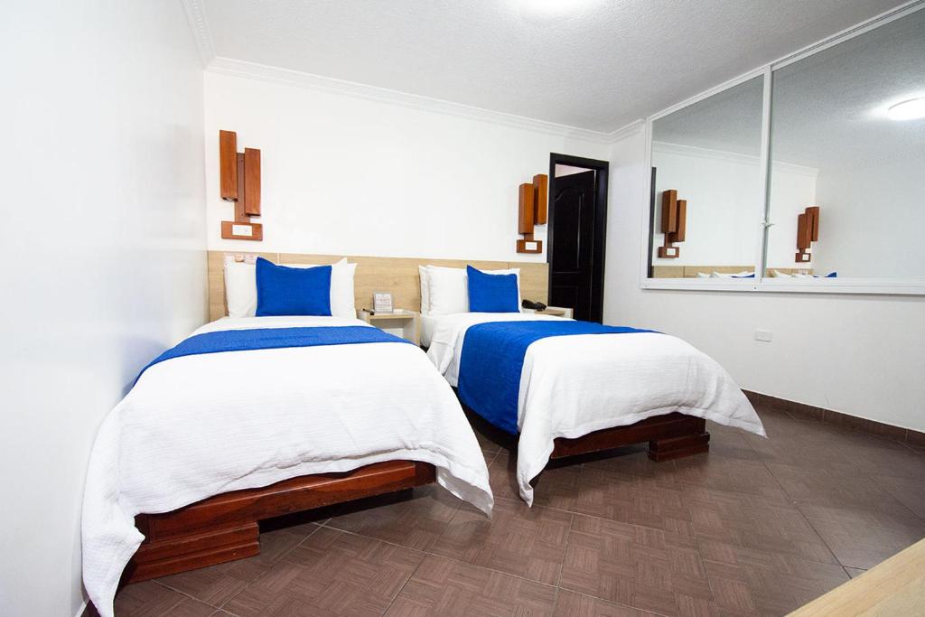 Postel nebo postele na pokoji v ubytování Hotel Plaza Victoria