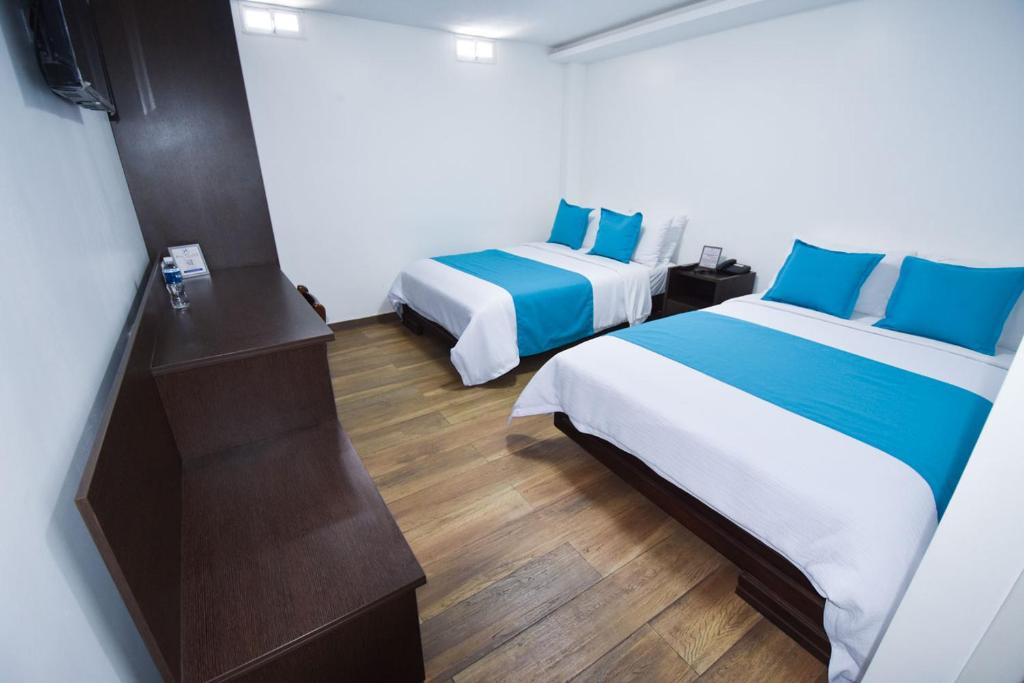 Postel nebo postele na pokoji v ubytování Hotel Plaza Victoria