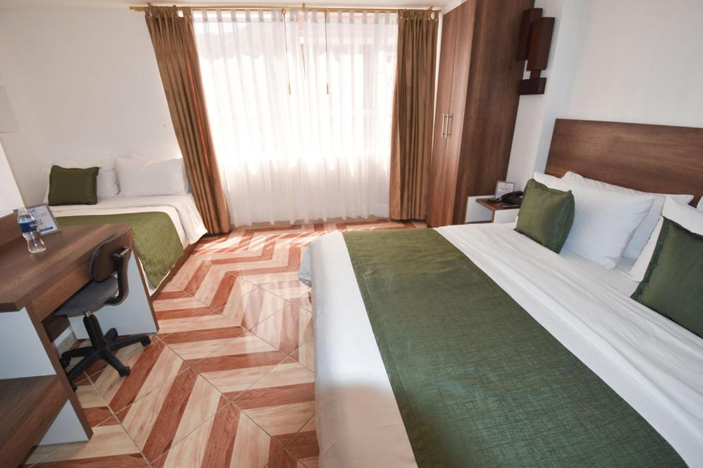 Postel nebo postele na pokoji v ubytování Hotel Plaza Victoria