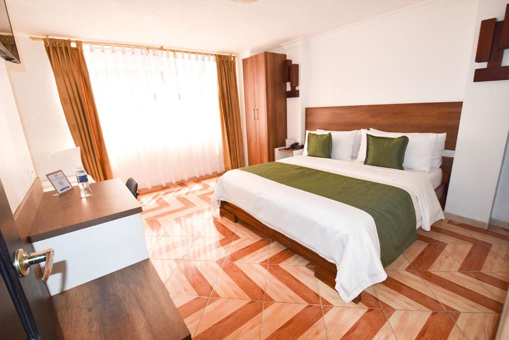 Postel nebo postele na pokoji v ubytování Hotel Plaza Victoria