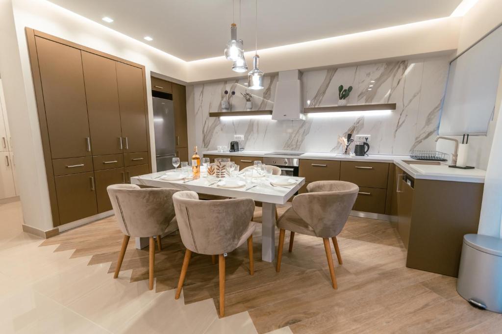 a kitchen with a dining room table and chairs at Elegant Suite 5' Min Kos Central in Platánion