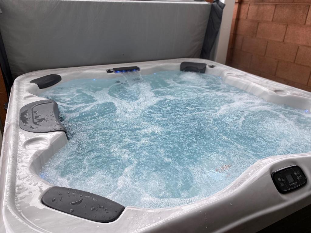 a jacuzzi tub with blue water in it at Harper House in Santa Clara