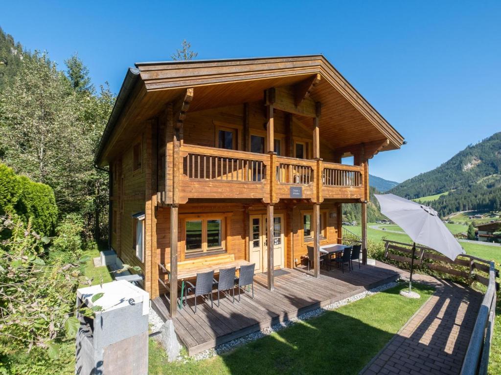 a log house with a deck and a patio at Windau in Krimml