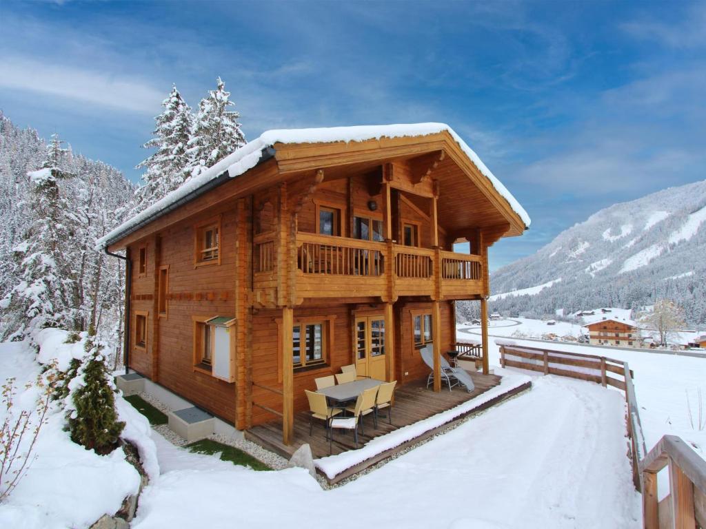 a log cabin in the snow with a table at Windau in Krimml