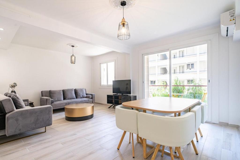 a living room with a table and a couch at Brand new 2 bedroom in the heart of Cannes in Cannes