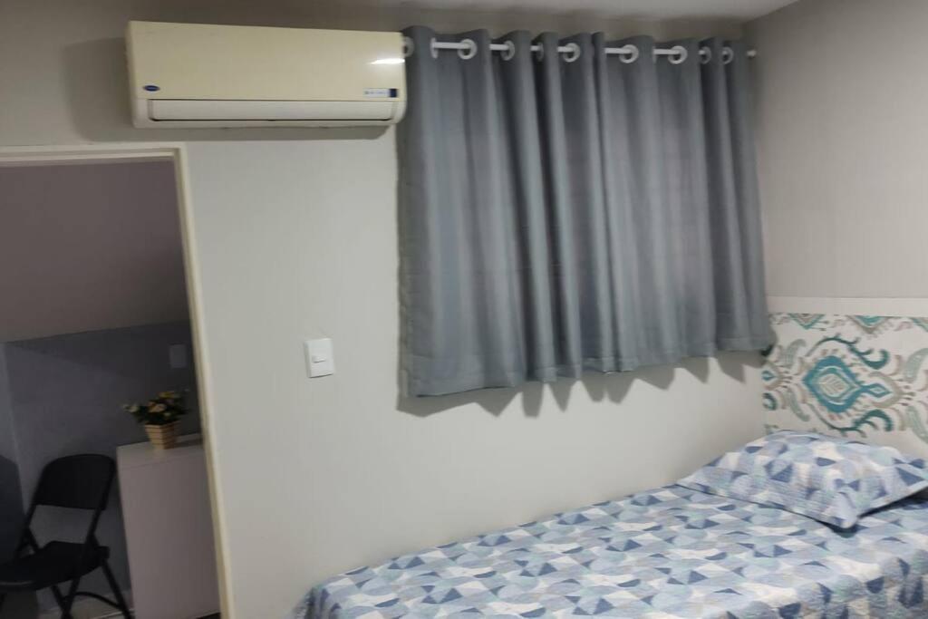 a bedroom with a bed and a window with a heater at Wana casa 4 -Requinte e Conforto in Sao Jose do Rio Preto