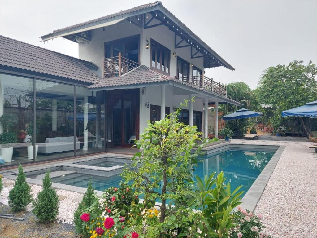 a house with a swimming pool in front of it at Thao’s Villa in Ho Chi Minh City