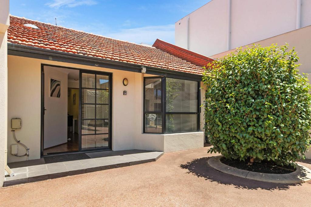 a house with a large bush in front of it at Swan River Applecross Heathcote Park 1BR Villa in Perth