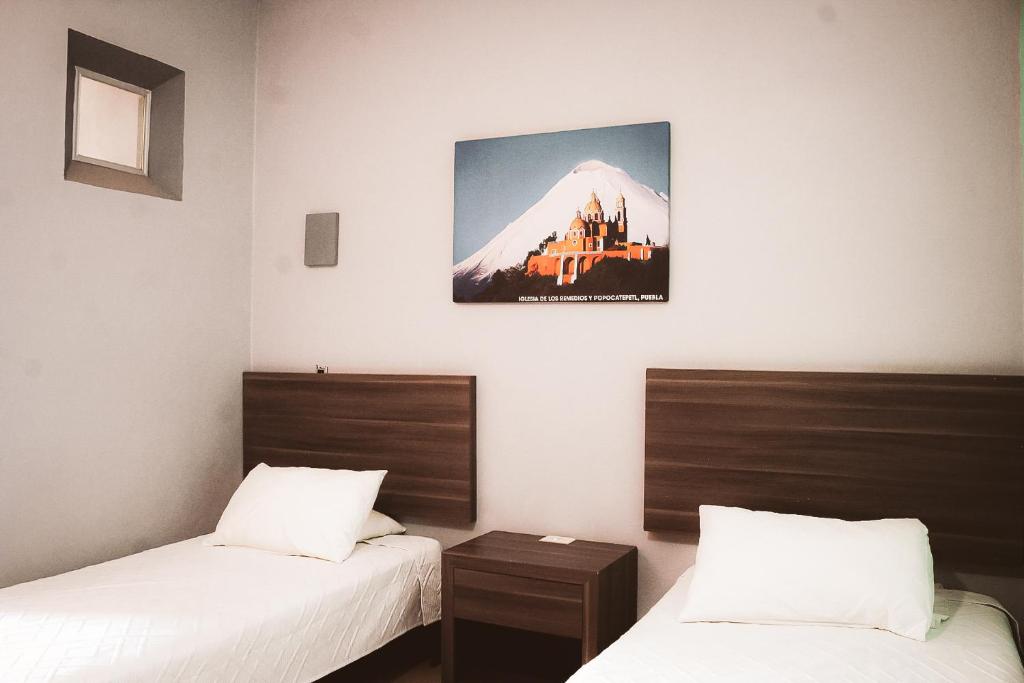 Postel nebo postele na pokoji v ubytování La Conspiración Hotel