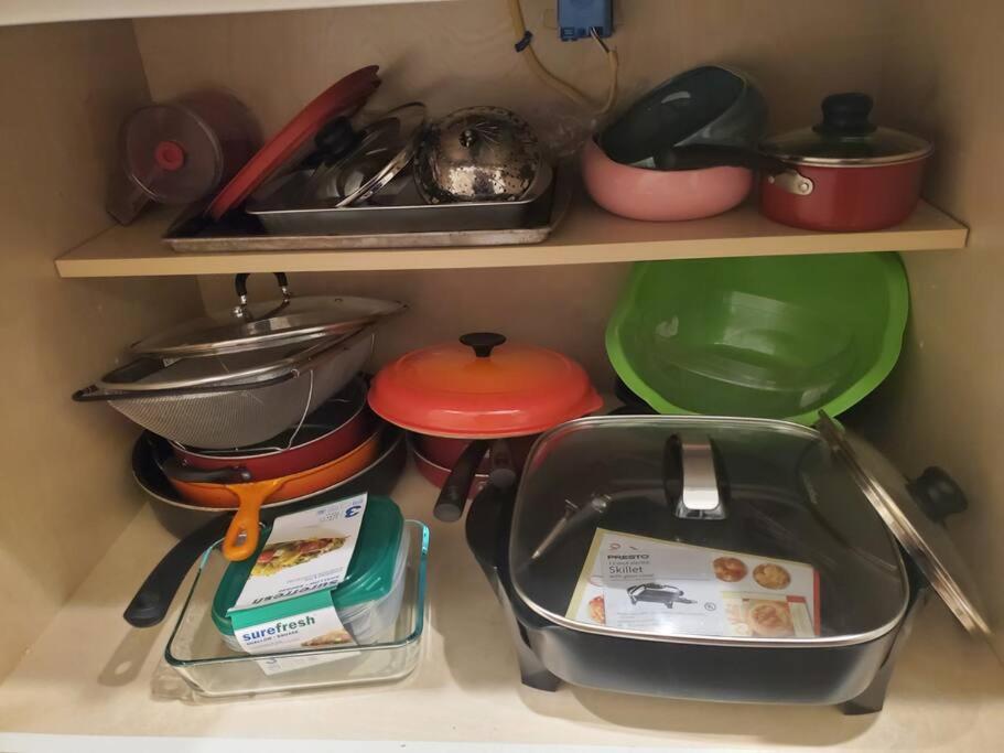 a kitchen shelf filled with pots and pans at Beautiful New 4 Bedroom 3 Bath Family Home Nr Howard U Downtown NW DC in Washington