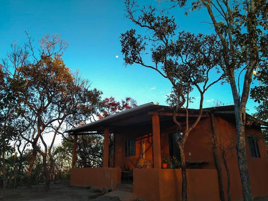 a small house with trees in front of it at Residência Sol e Lar in Sao Jorge