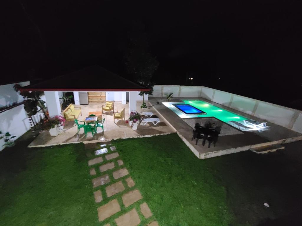 an overhead view of a backyard at night with a swimming pool at Villa Grecko Place in Jarabacoa