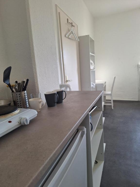 a kitchen with a counter top in a room at hoteliving Apartments Gießen-Süd in Gießen