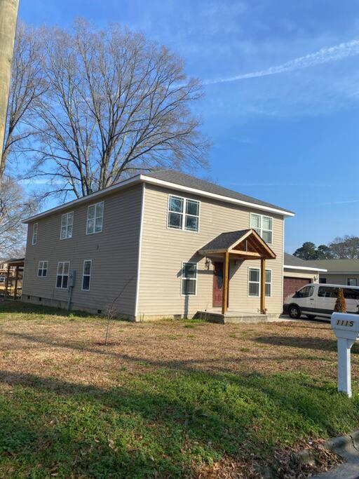 a house with a car parked in front of it at Large 5 Bedroom Home Near Downtown Dalton in Dalton