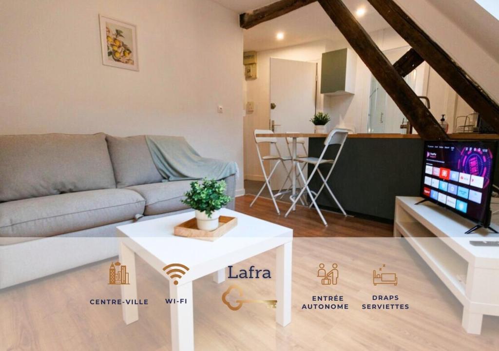 a living room with a couch and a table at Lafra - Charming & Intimate - Mon Groom in Troyes