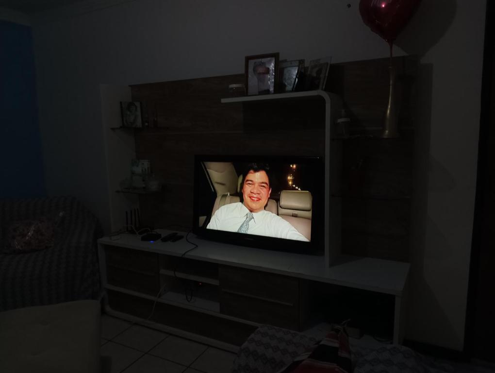 a tv screen with a woman on it in a dark room at Hóspede se bem e com custo beneficio em Salvador in Salvador