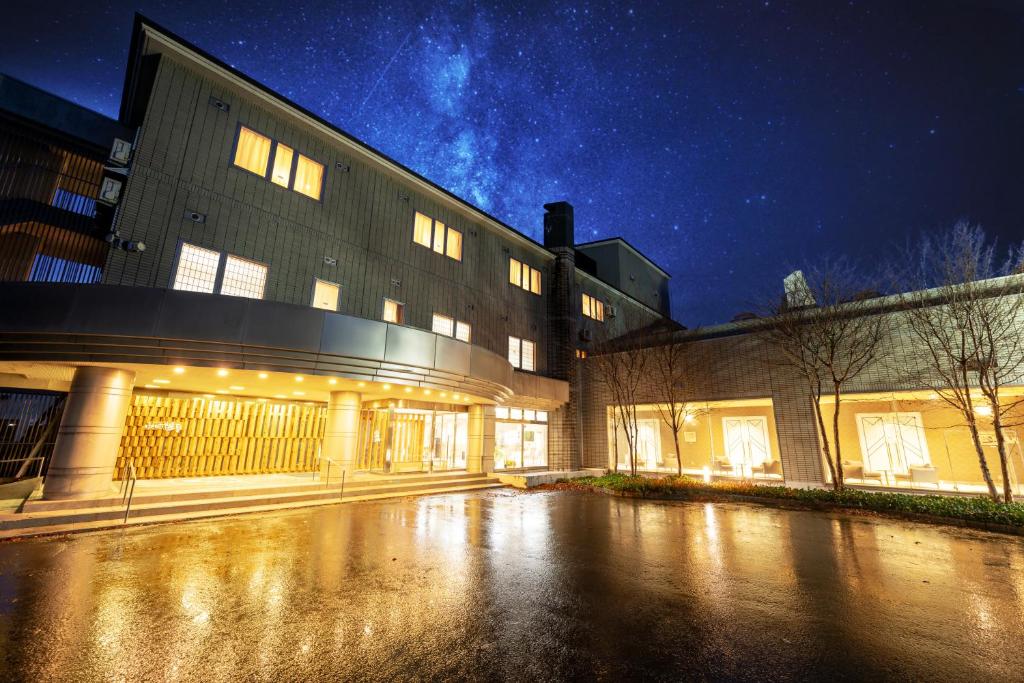 a building at night with the lights on at Hotel Yutoria Fujisato in Fujisato