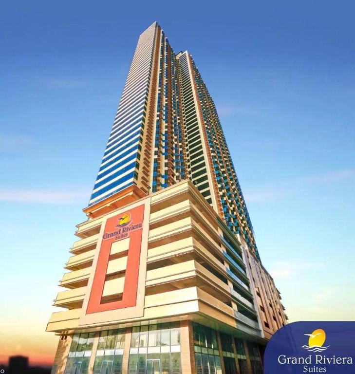 a tall building with a sign on the side of it at Dreamy Sunset Bay in Manila