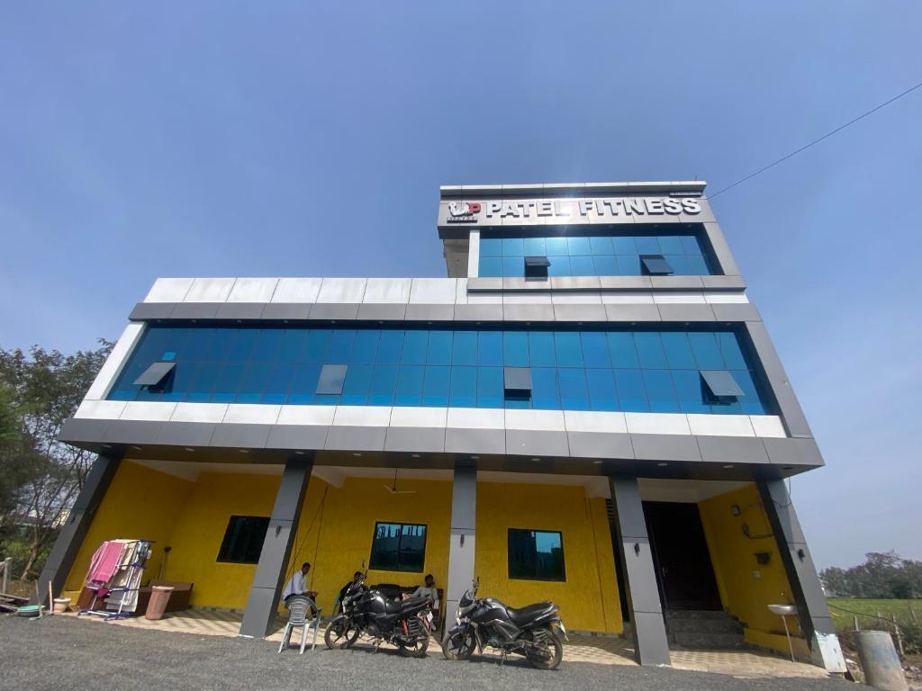 a building with two motorcycles parked in front of it at PATEL HOTEL in Shamsgarh