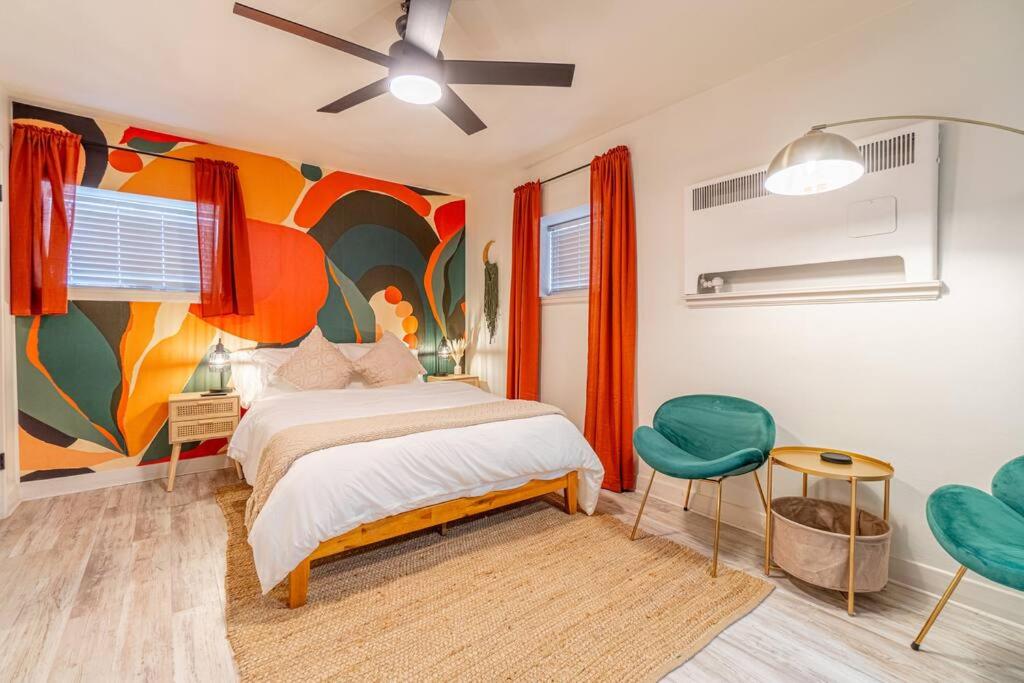 a bedroom with a bed and a painting on the wall at Riverside Luxe: Stylish Designer Retreat in Reno