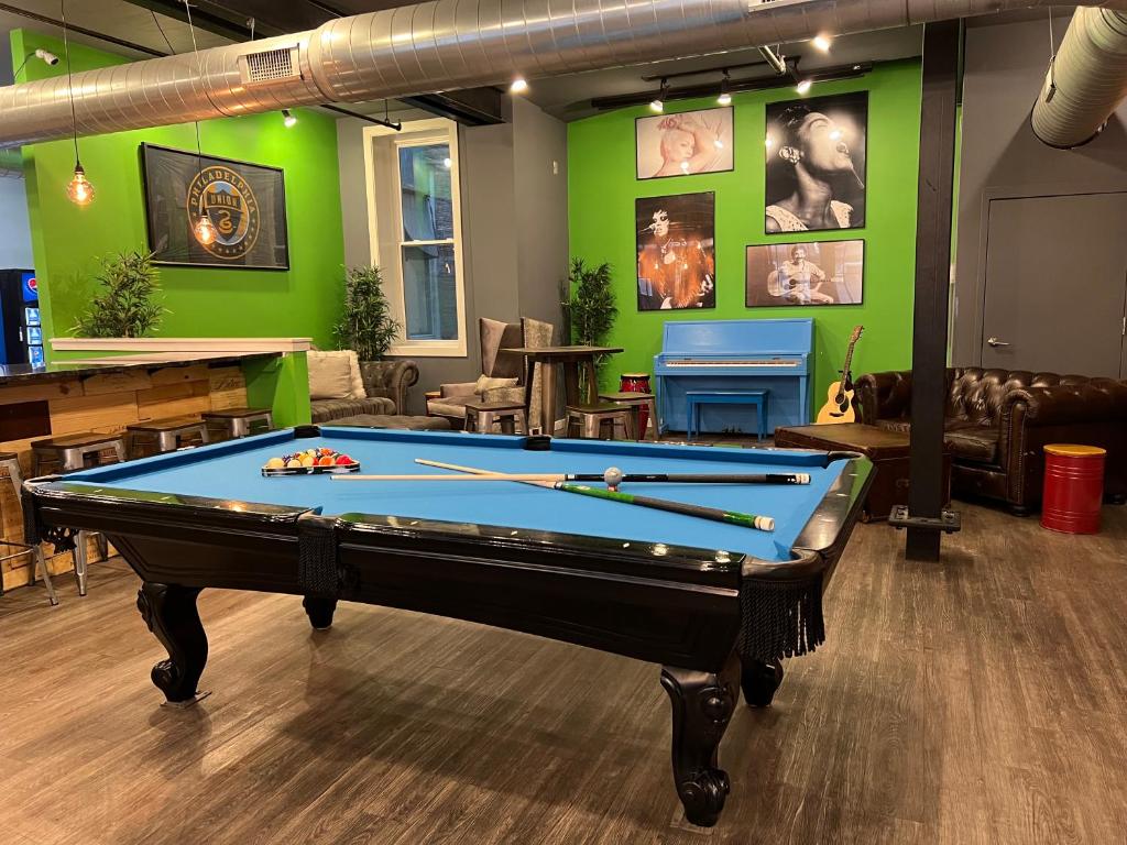 a pool table in a room with green walls at Apple Hostels of Philadelphia in Philadelphia