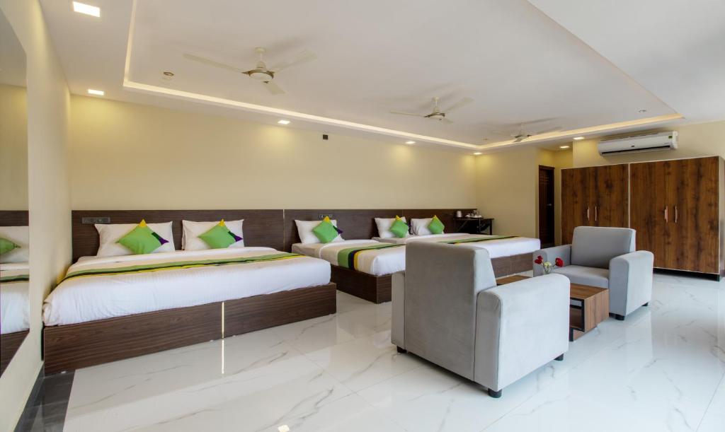 Ένα ή περισσότερα κρεβάτια σε δωμάτιο στο Treebo Jaguar Comforts, 3 Kms From Mahatma Gandhi Park