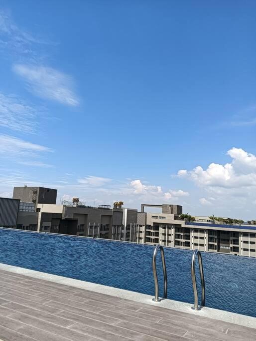 a swimming pool with buildings in the background at D-29-08 / Youth City / Nilai / Infinity pool in Nilai