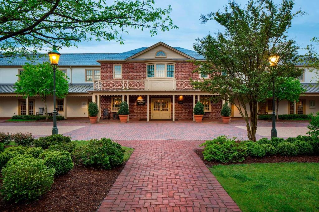 a large brick house with a brick driveway at Williamsburg Lodge, Autograph Collection in Williamsburg