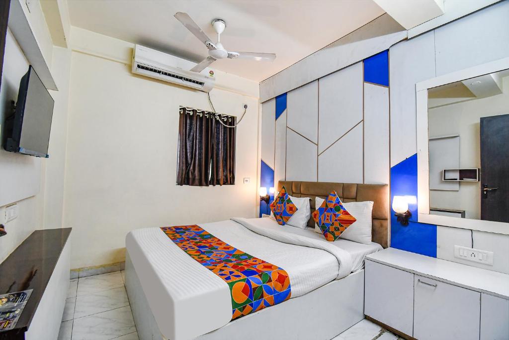 a bedroom with a bed and a ceiling fan at FabHotel Green Leaf I in Kolkata